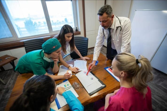 Clinical team reviewing patient case notes in a consultation room